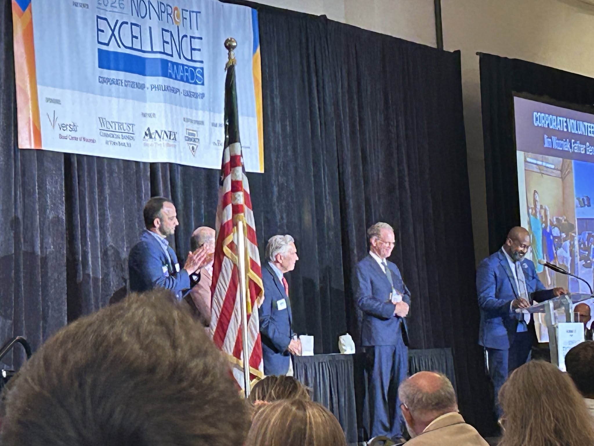Jim Wozniak recognized on stage as a finalist for Corporate Volunteer of the Year